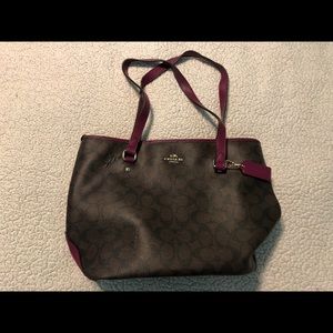 Dark brown Coach purse with purple trim.